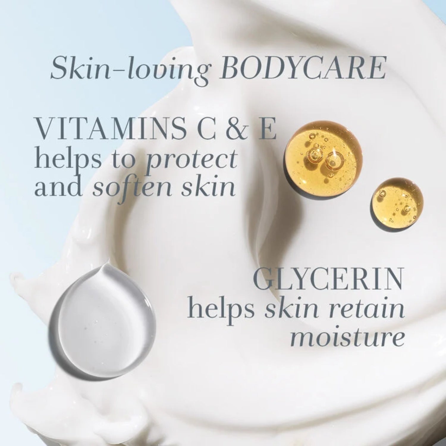 White body lotion smear on skin with small gold capsule-like details