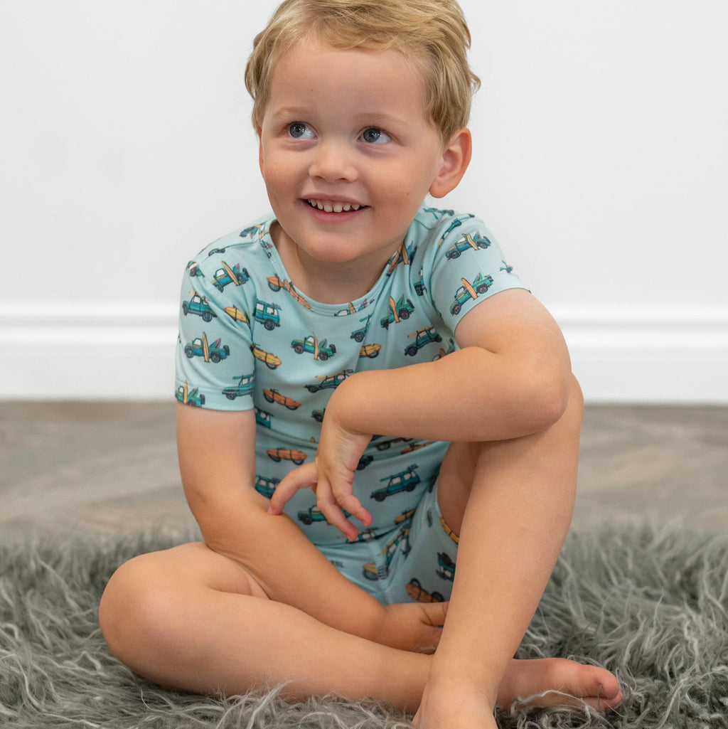 Boys pajama shirt in light blue with colorful surfboard and truck print