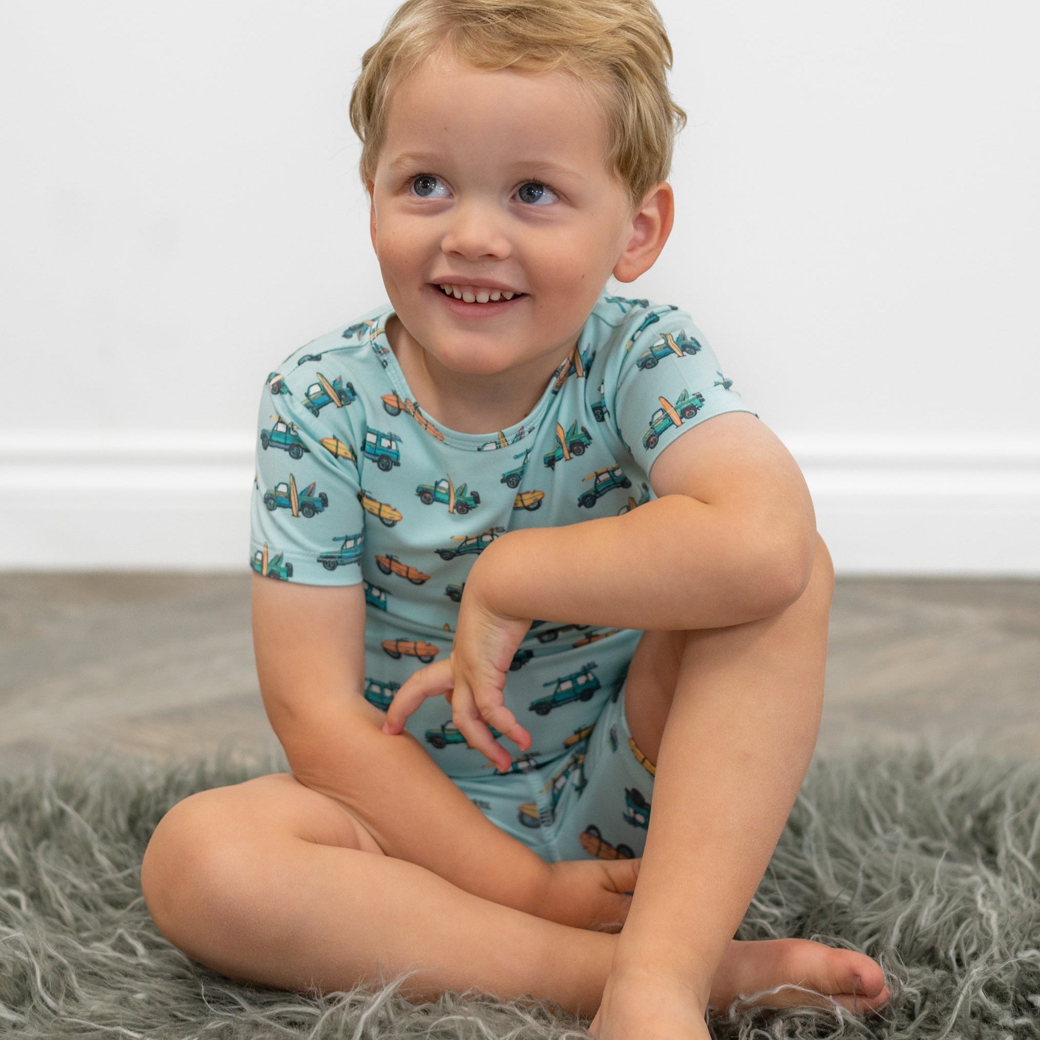 Boys pajama shirt in light blue with colorful surfboard and truck print