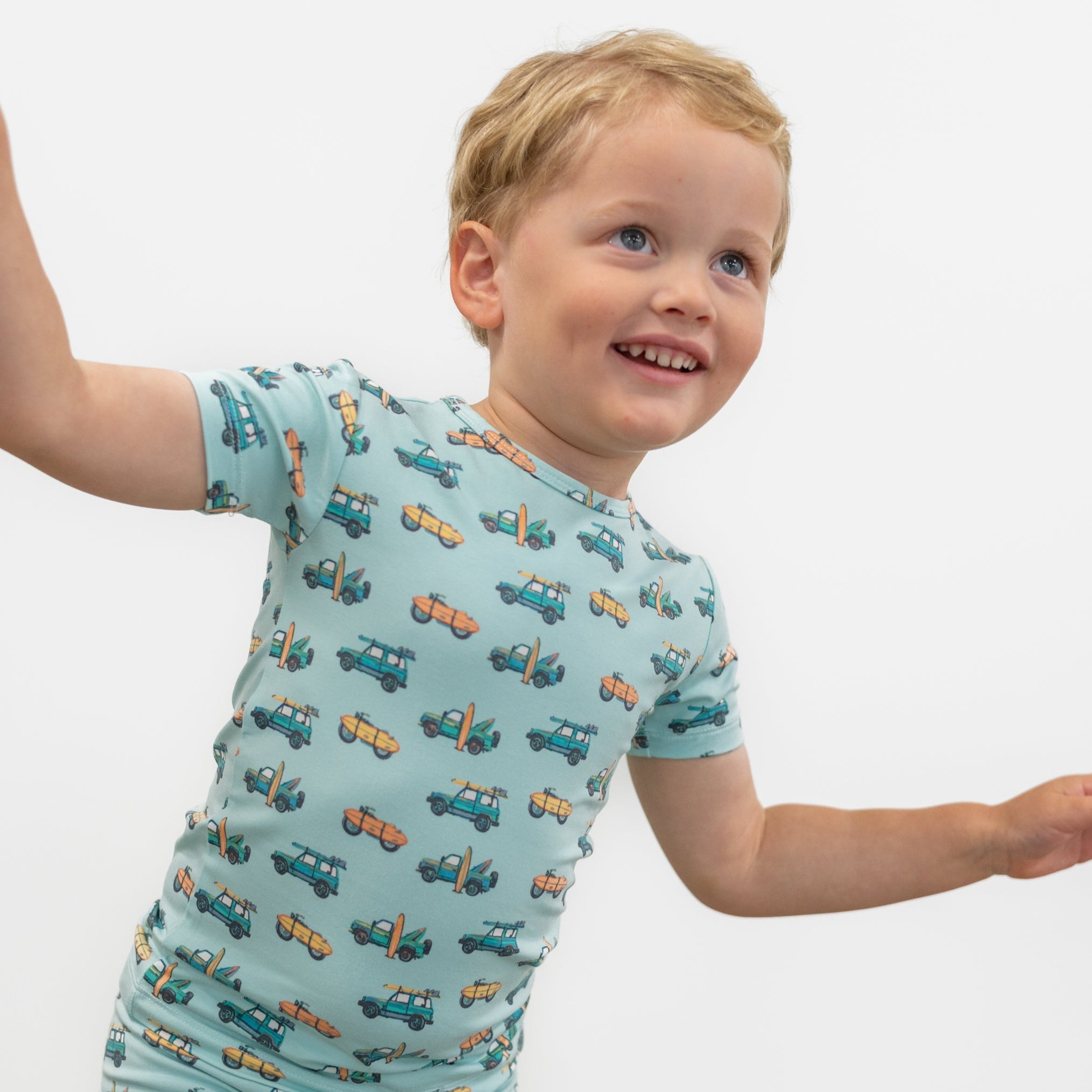 Boys light blue pajama shirt and shorts with surf-and-vehicle print, short sleeves