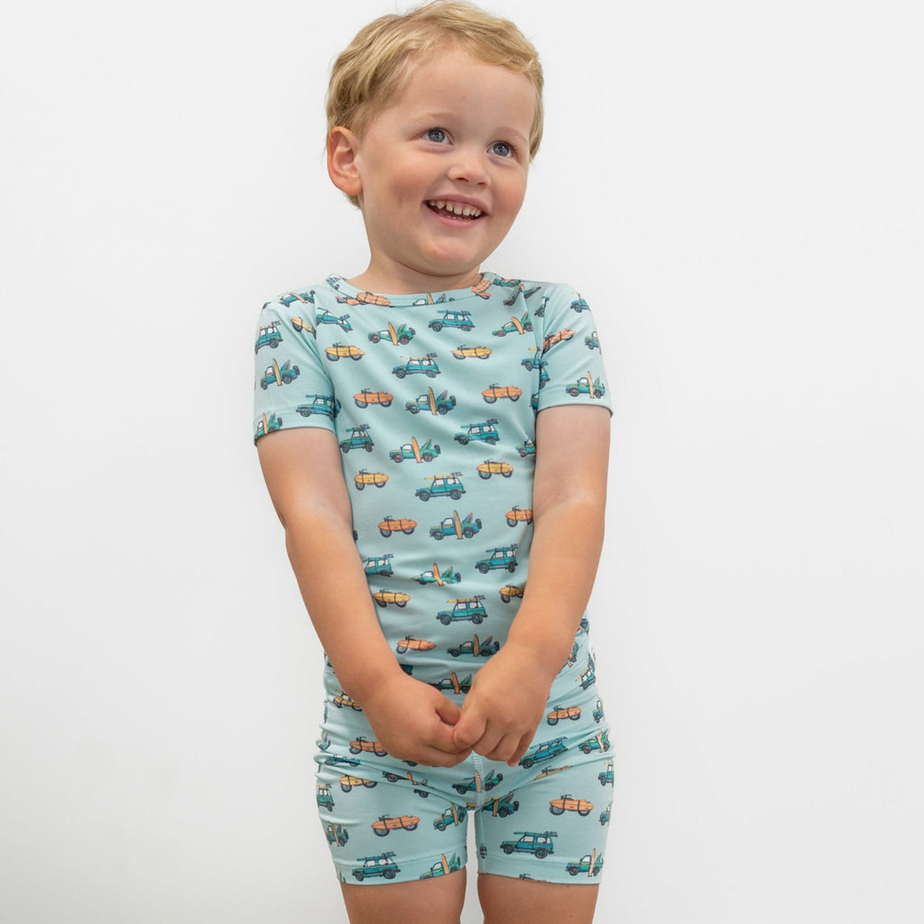 Boys light blue pajama top and shorts set with surf-and-vehicle allover print