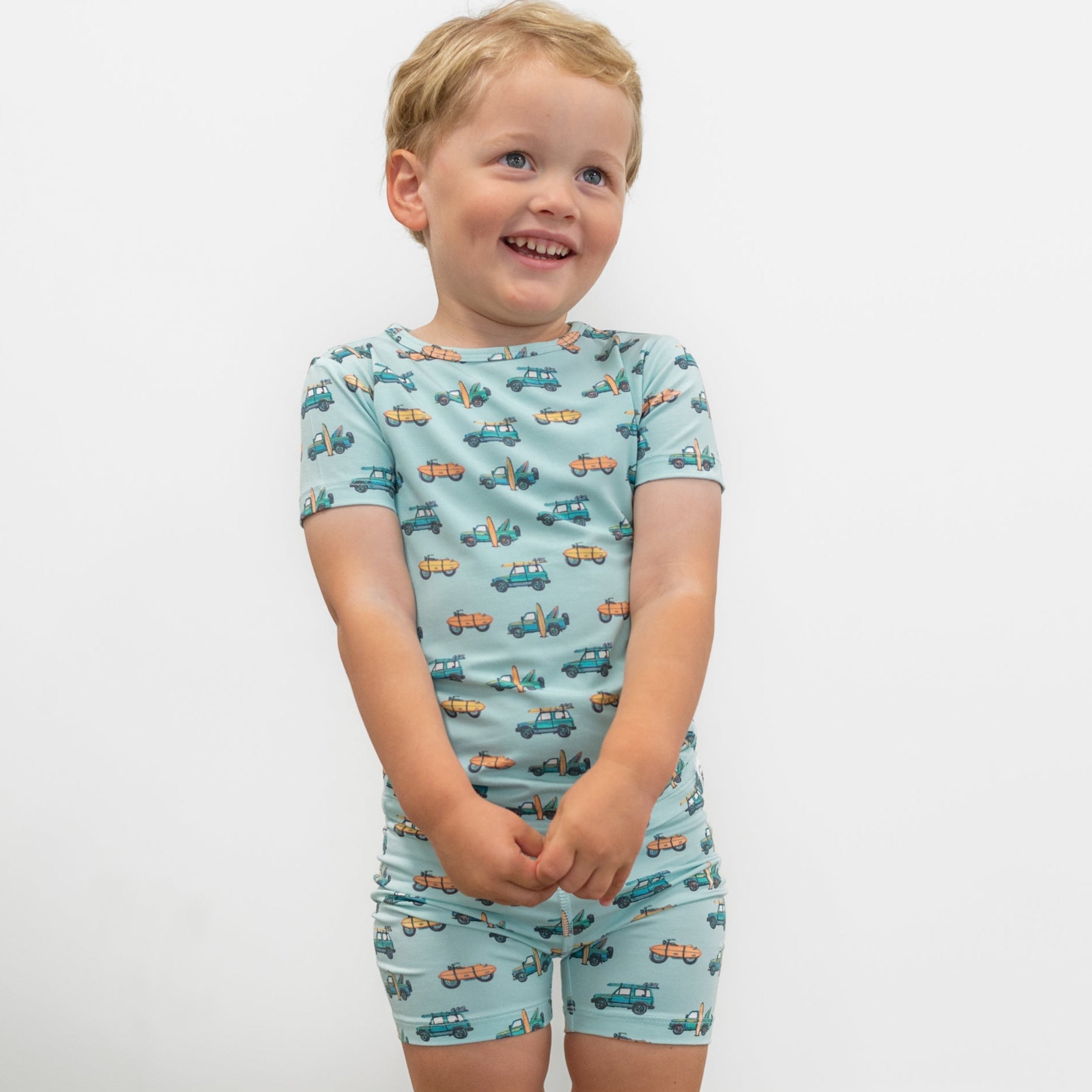 Boys light blue pajama top and shorts set with surf-and-vehicle allover print