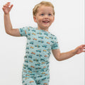 Boys light blue pajama set top with short sleeves and allover surf-and-vehicles print