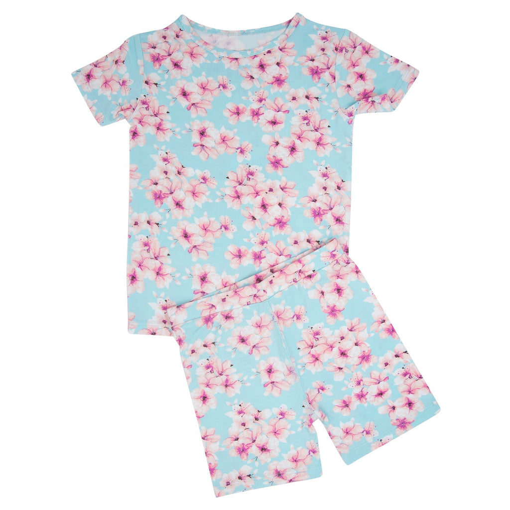 Girls' light blue floral pajama set with pink blossoms, short-sleeve top and shorts
