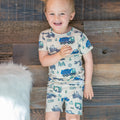 Kids' construction pajama set on boy, short-sleeve shirt and shorts with vehicle print