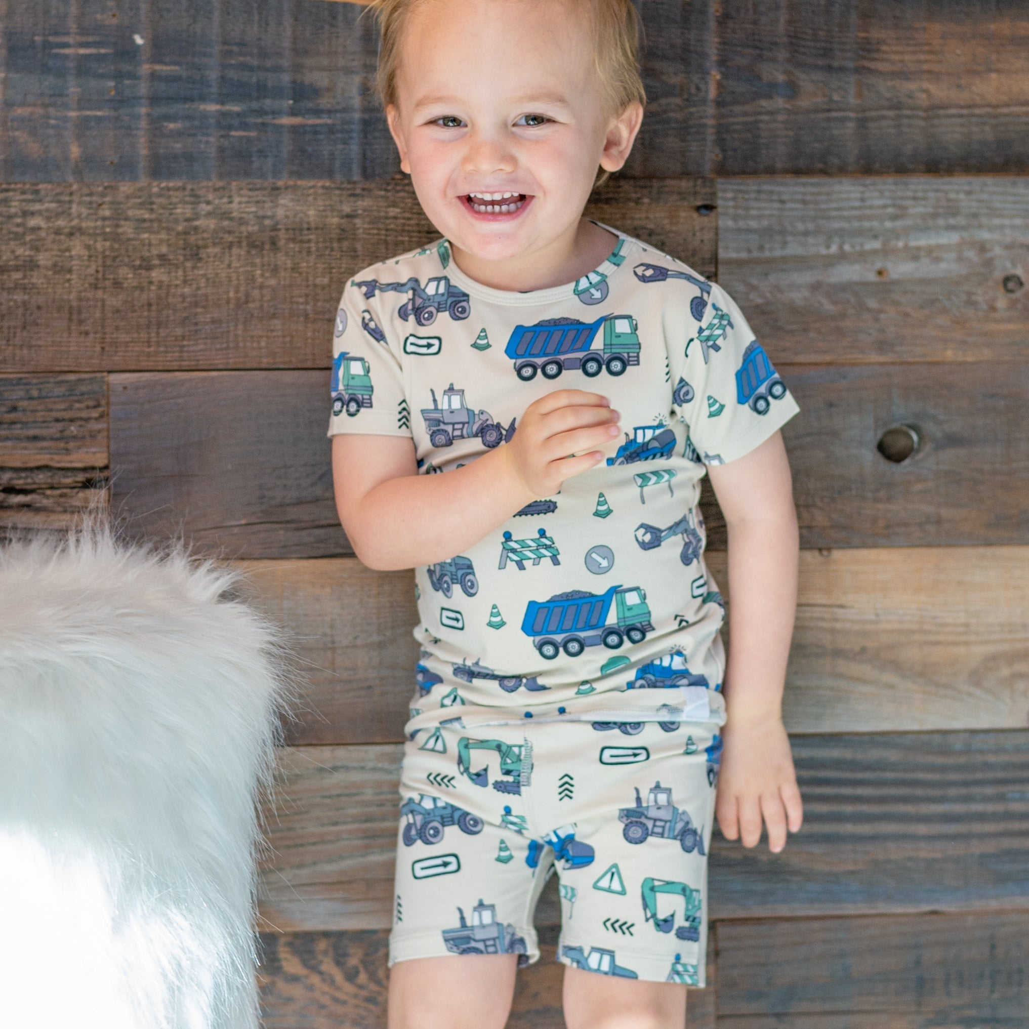 Kids' construction pajama set on boy, short-sleeve shirt and shorts with vehicle print