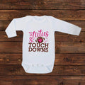 White long-sleeve baby bodysuit with 'Tutus & Touch Downs' pink text and heart
