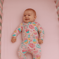 Baby girl footie pajama in pastel cupcake print, long sleeves and full-length legs