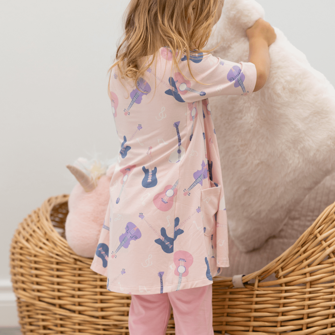 Girls’ guitar-print tunic with round neckline, short sleeves, and light pink leggings