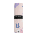 Light pink musical swaddle blanket with blue guitars and purple notes