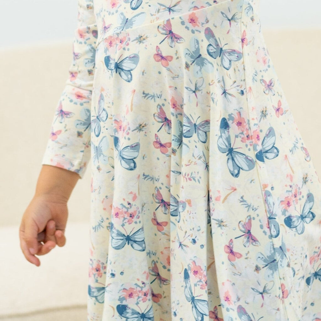 Girls watercolor butterfly dress with long sleeves and gathered skirt, light cream