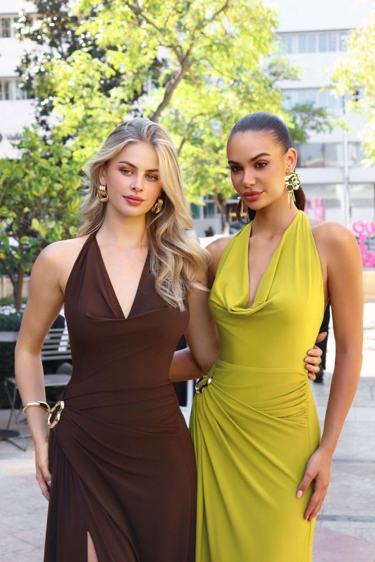 Long halter-neck sleeveless evening gown in brown with deep V neckline and side slit.