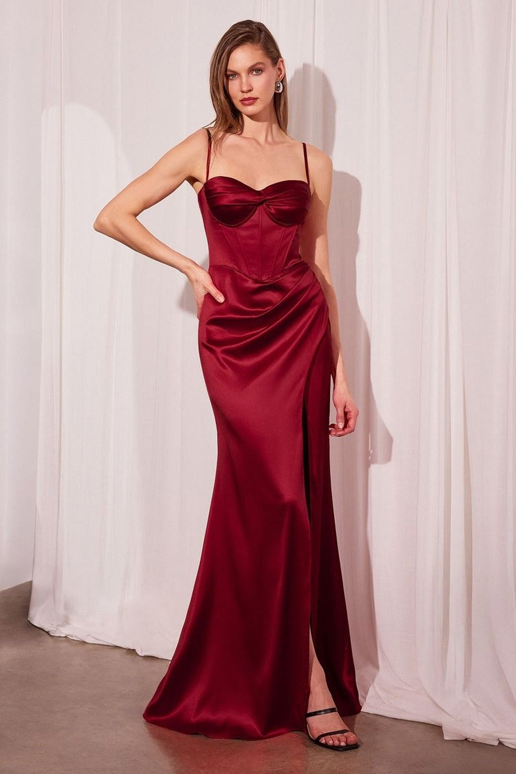 Long fitted satin prom gown in deep red, corset bodice, thigh-high slit