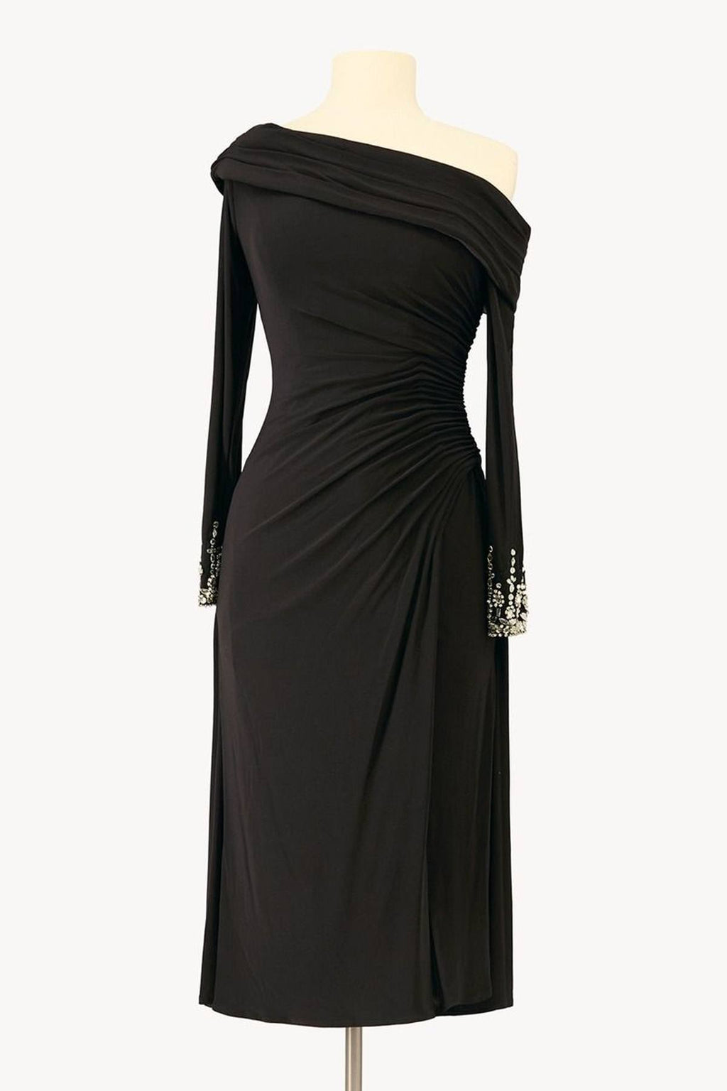 Black off-shoulder long-sleeve dress on mannequin, ruched drape at waist
