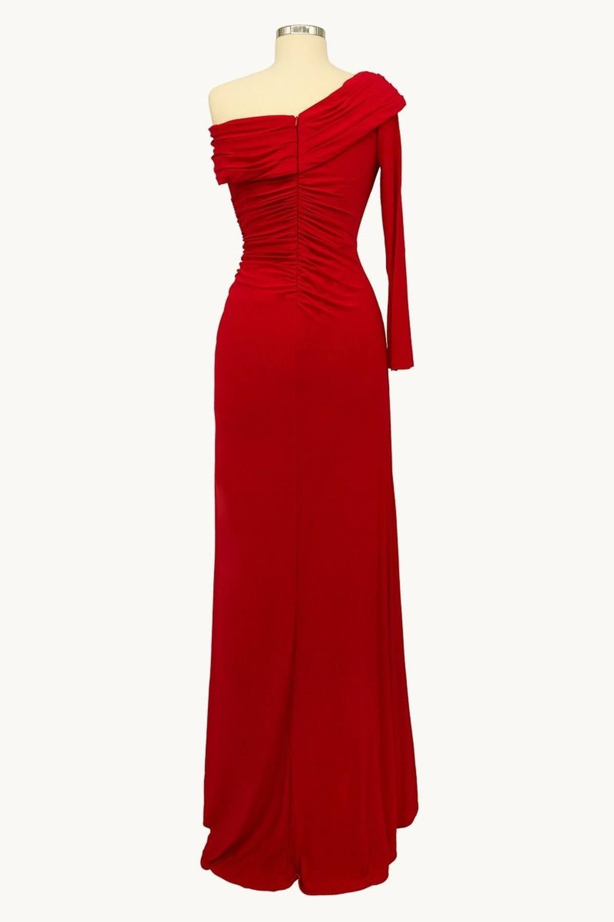 Red one-shoulder fitted gown with draped neckline and thigh slit