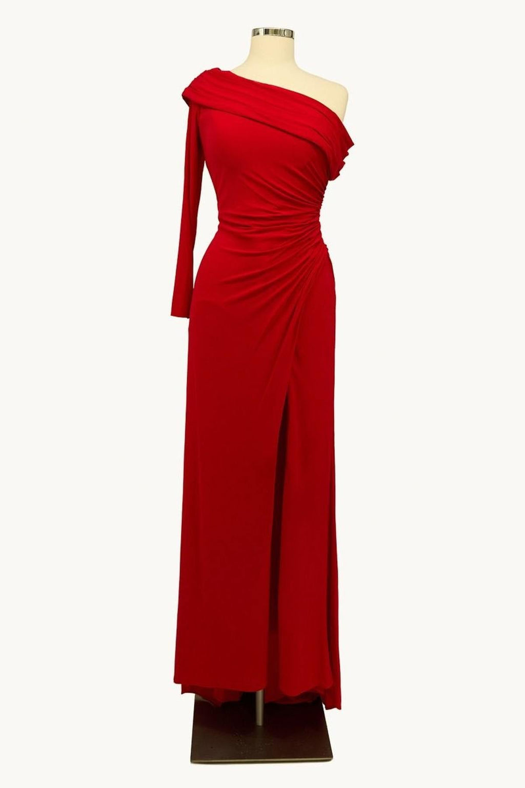 Red one-shoulder fitted gown with draped neckline and long skirt with slit