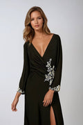 Black long-sleeve V-neck gown with floral embellishment and side leg slit