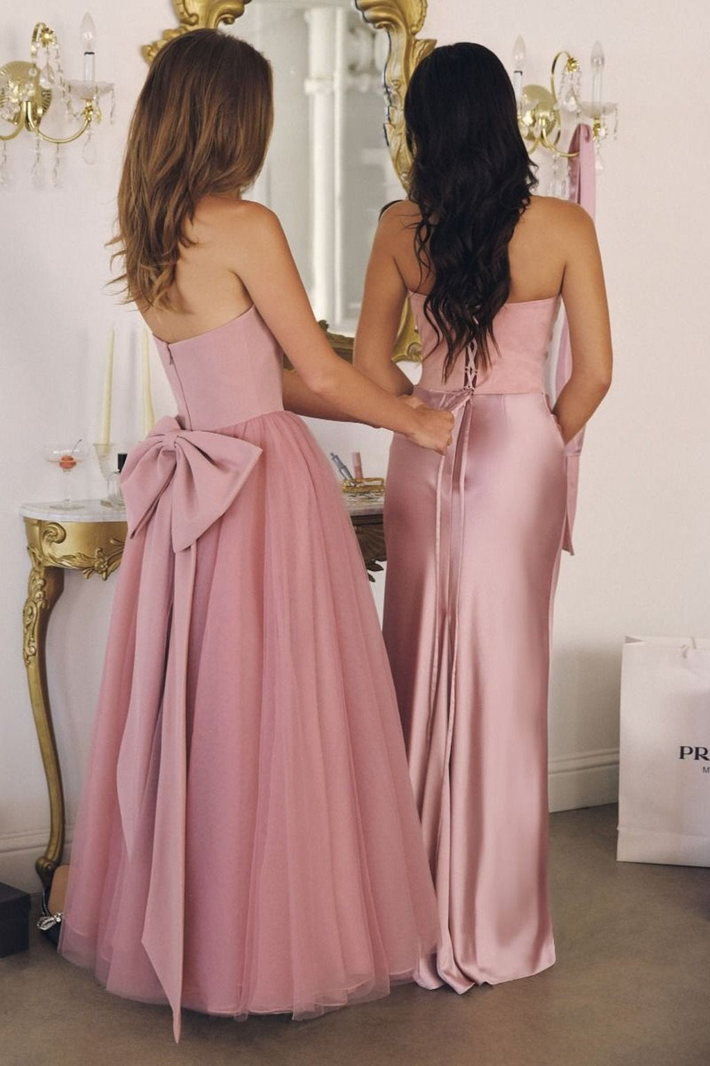 Blush pink strapless A-line gown back view with bow at waist and layered skirt