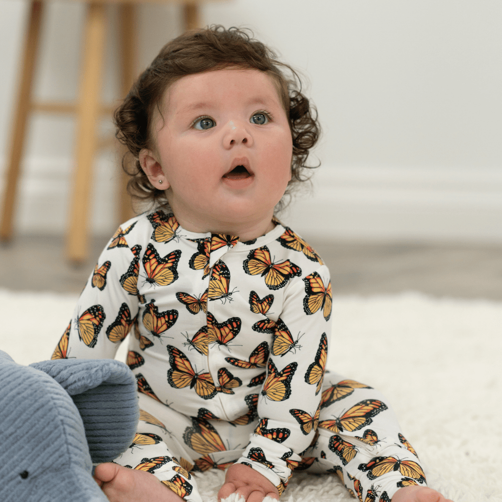 Butterfly-print long-sleeve romper in white with orange and black butterflies