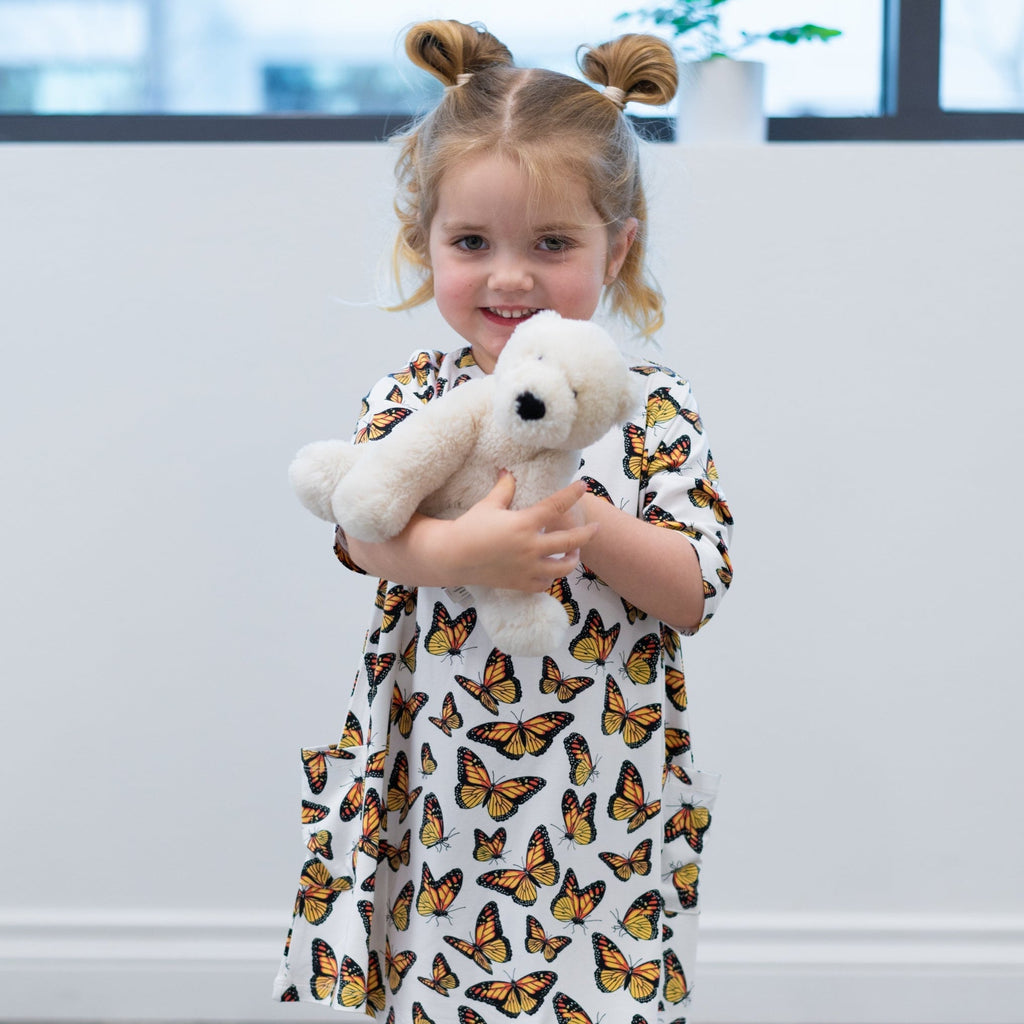 Girls butterfly tunic with short sleeves, holding a white plush bunny