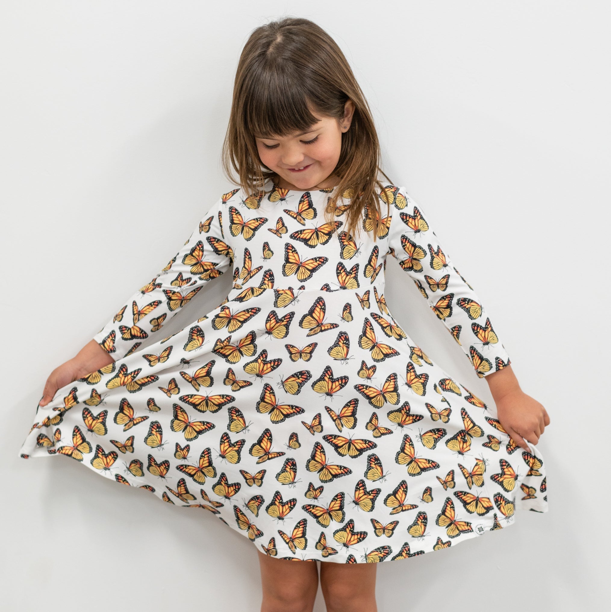 Girls' swirly dress with butterfly print, long sleeves, flared gathered skirt