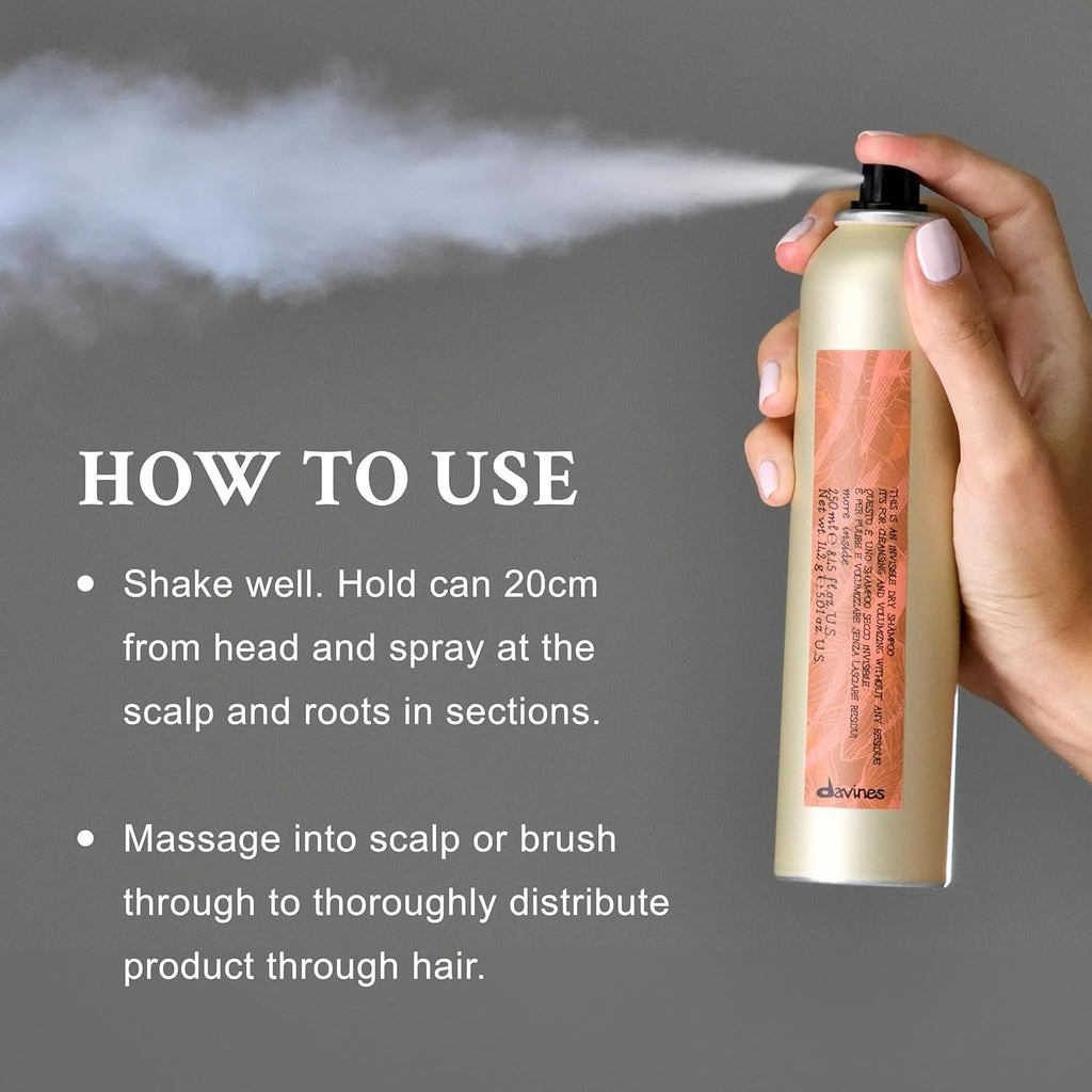 Davines invisible dry shampoo bottle in hand, mist spraying from nozzle