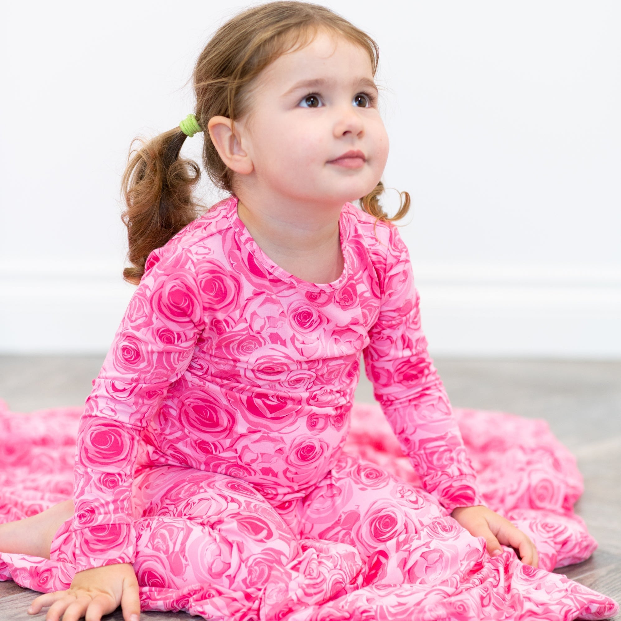 Kids pink rose-pattern pajama set, worn by child, long sleeves and pants