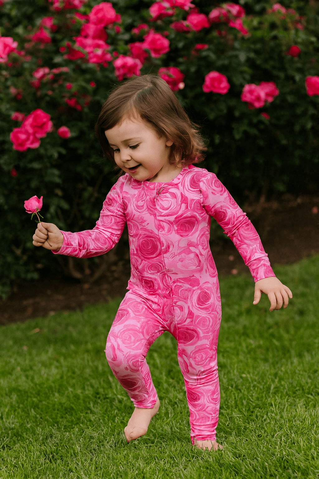 Girl's pink rose-print long-sleeve romper, front view, full-body
