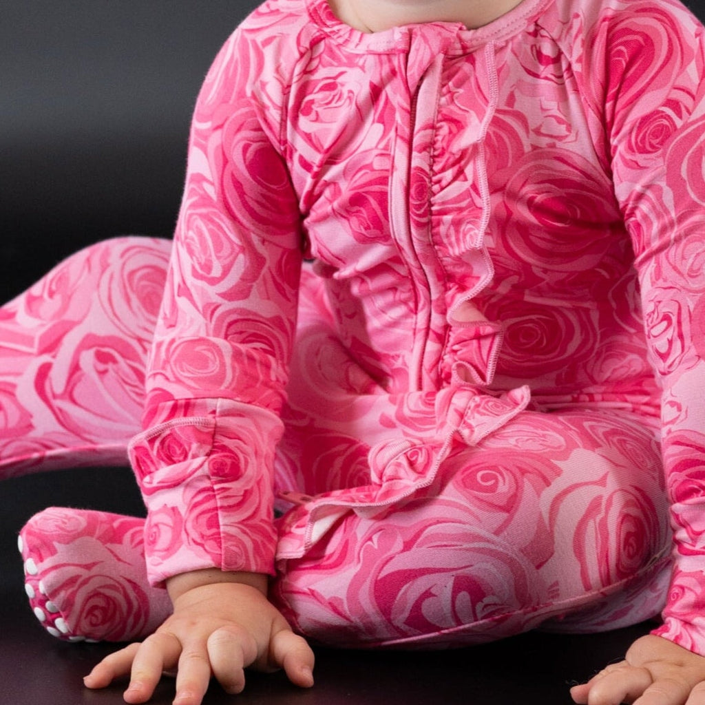 Pink rose-print long-sleeve footie with ruffled neckline and leg cuffs