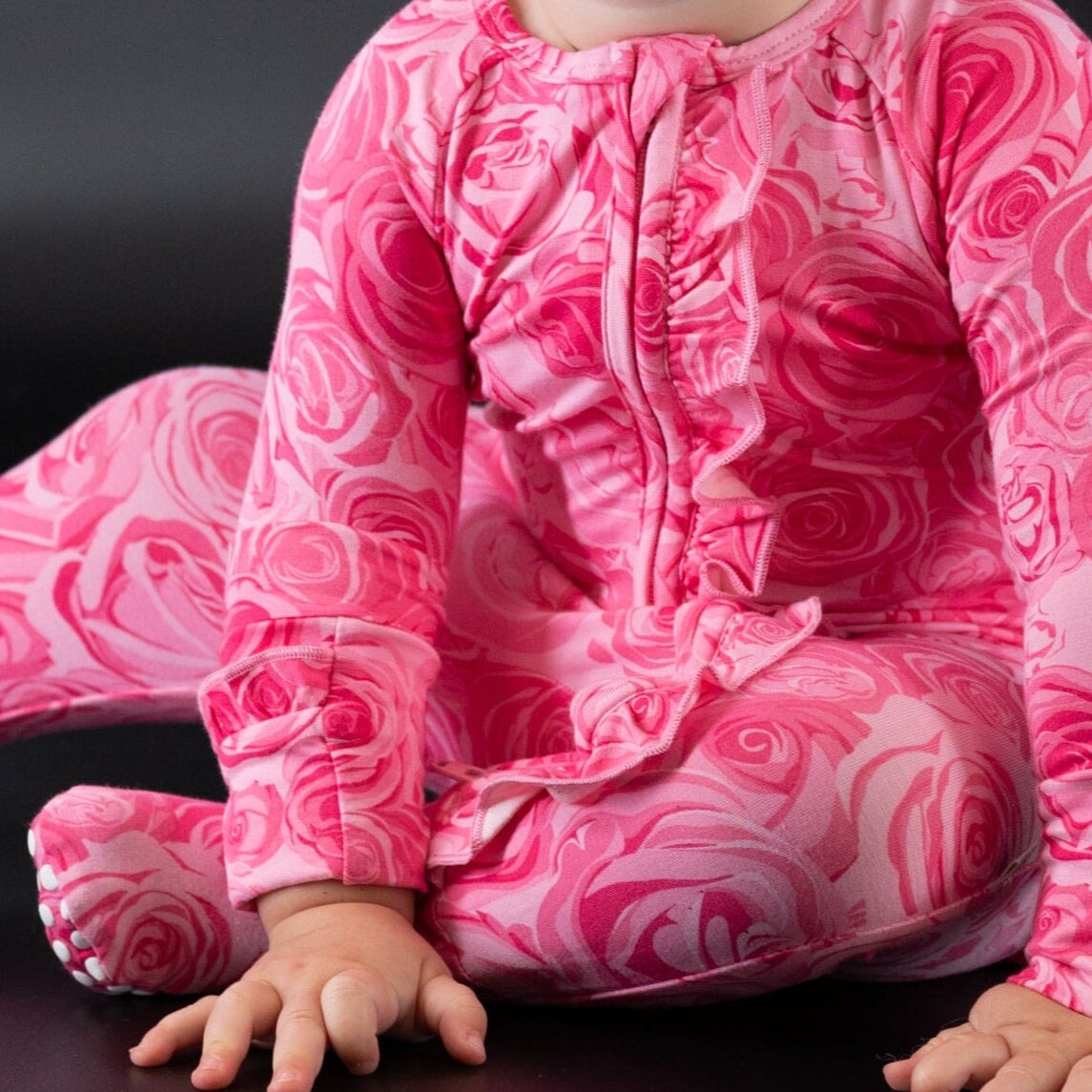 Pink rose-print long-sleeve footie with ruffled neckline and leg cuffs