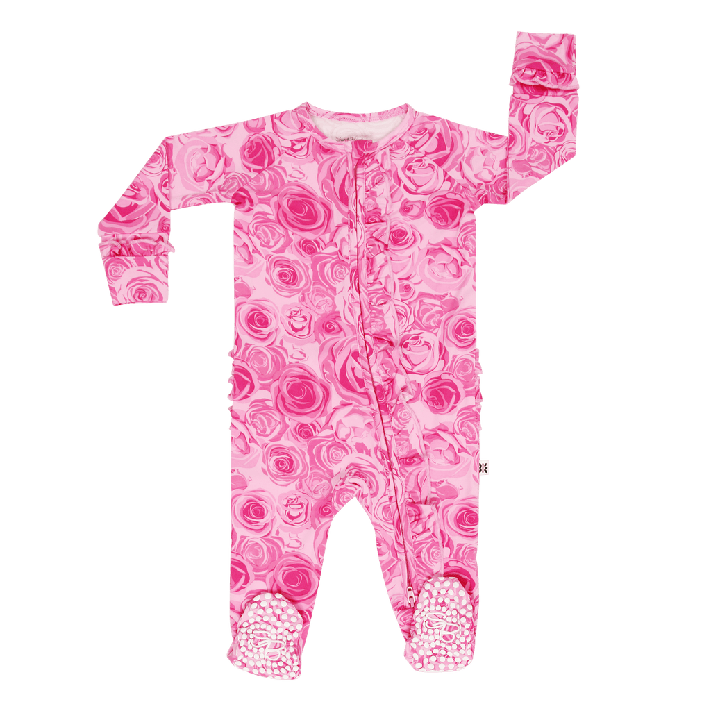 Pink rose-print baby footie romper with long sleeves, ruffled neckline, and feet