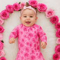 Pink rose-print footie romper with long sleeves and footed legs for baby girl