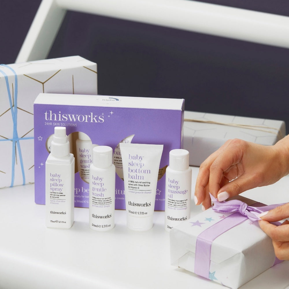 Baby sleep bedtime ritual gift set with skincare bottles and ribbon-wrapped gift