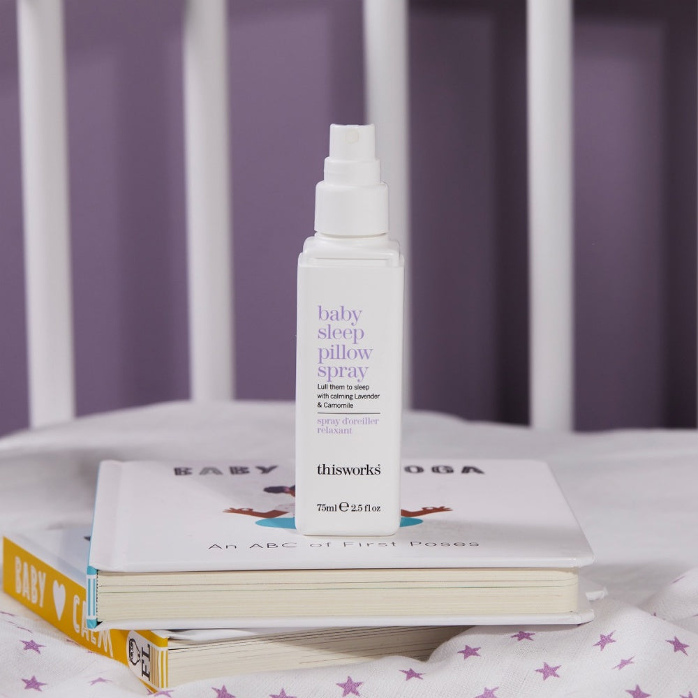 Baby sleep pillow spray bottle on books with patterned kids cover