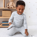Kids long-sleeve pajama set on child, light blue with rocket and planet print