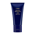 Oribe Supershine cream tube with navy-blue body and gold logo on front