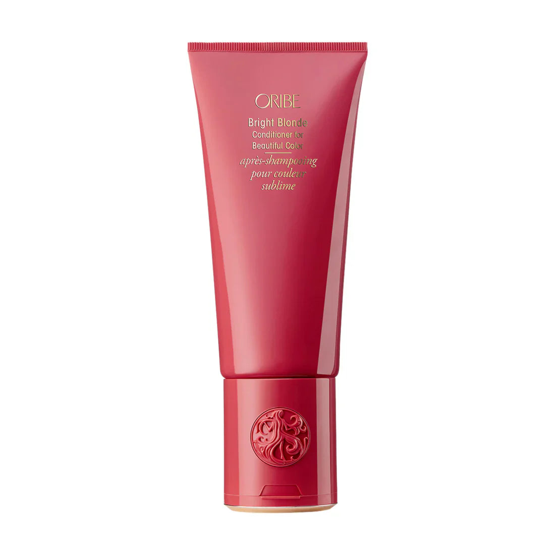 Oribe conditioner tube, pink magenta, circular gold emblem near the bottom