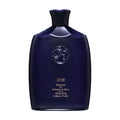 Oribe shampoo bottle, dark navy blue plastic with flip-top cap and embossed logo