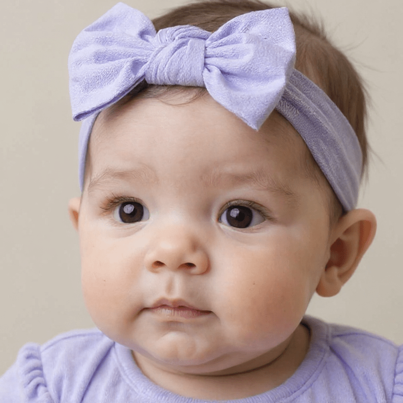 Lavender fabric bow headband on baby girl