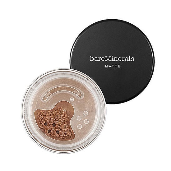 Matte foundation compact with black lid and open jar showing light tan powder