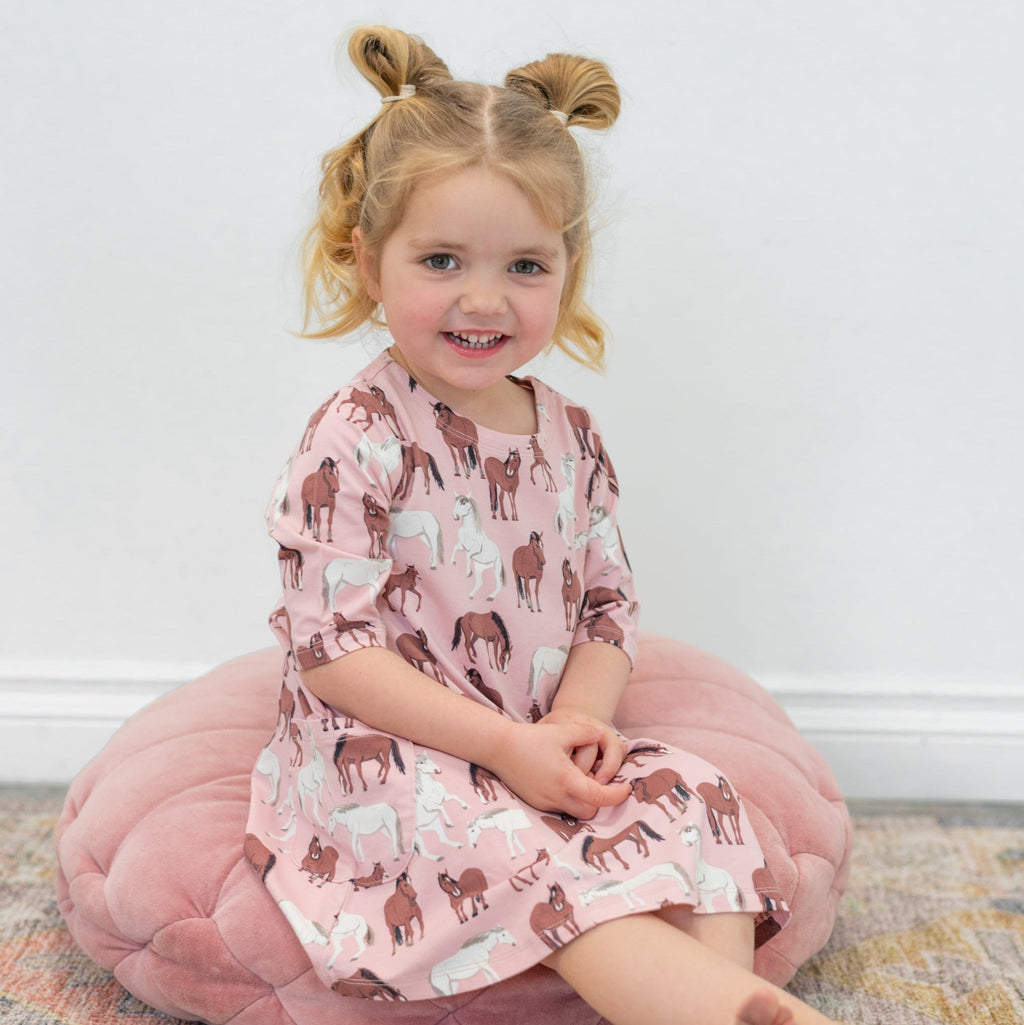 Girls' pink horse-print tunic with short sleeves, crew neckline, and straight hem