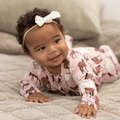 Girl zip-front horse-print footie in dusty pink, long sleeves and covered feet