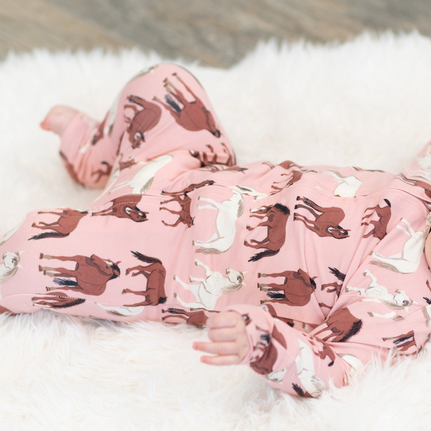 Pink horse-print zip-front footie with long sleeves and covered feet