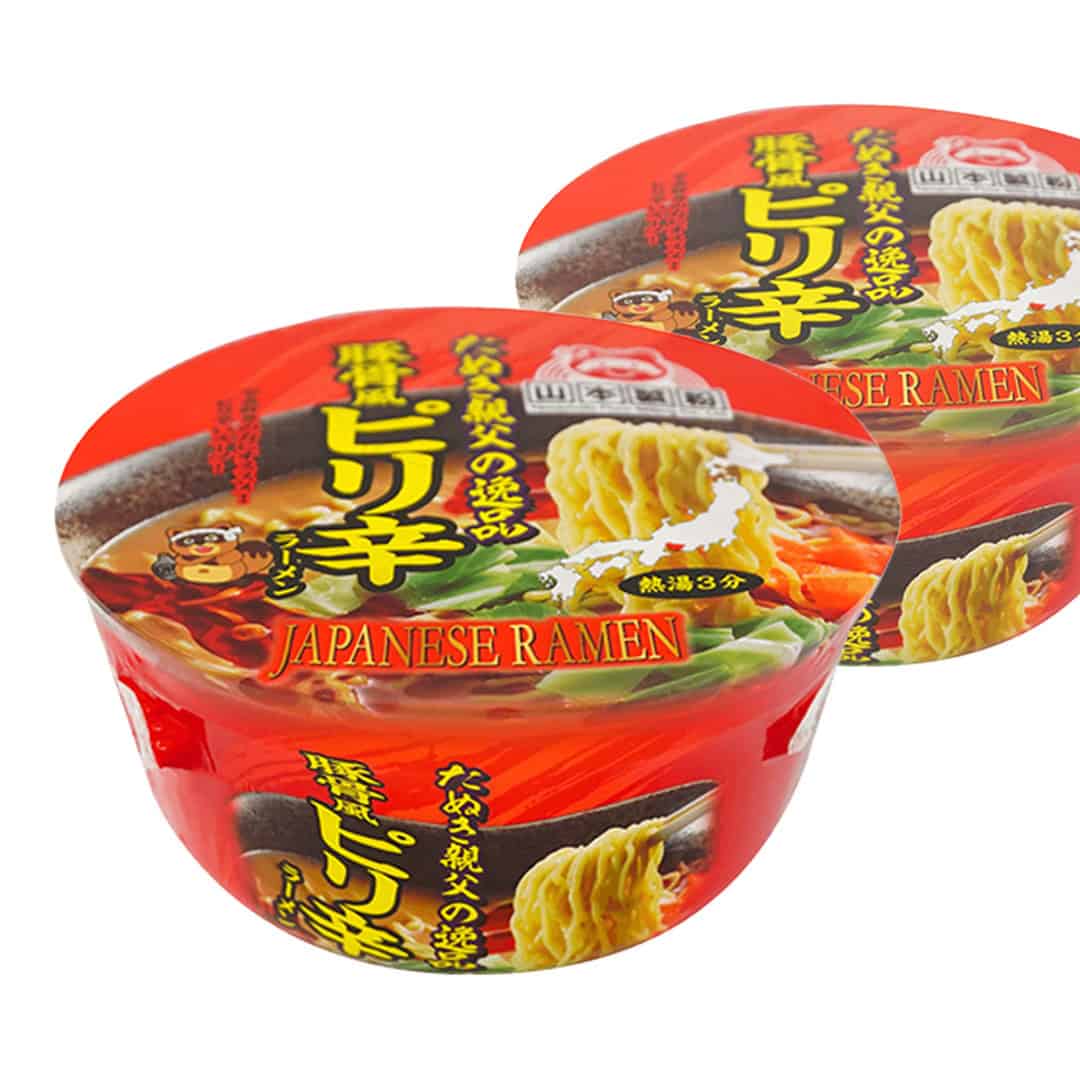 Hot Japanese ramen cup, red with curly noodle and seasoning graphics; two cups.