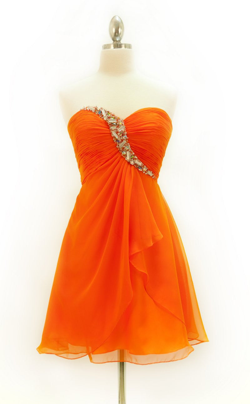 Orange strapless chiffon dress on mannequin with jeweled sweetheart bodice and layered skirt