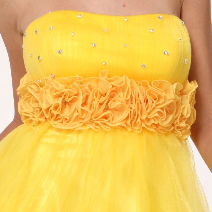 A-line tulle dress close-up: yellow strapless bodice with rhinestones and layered ruffles
