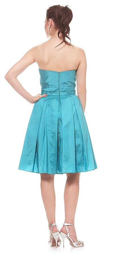 Teal knee-length A-line dress, back view, corset-style seams and skirt pleats