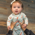 Light blue baby footie romper with cowboy boot and cactus print, zip front
