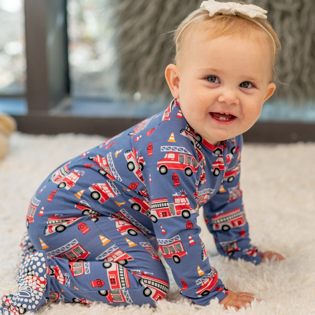 Blue fire truck zipper footie with red emergency vehicle pattern, long sleeves