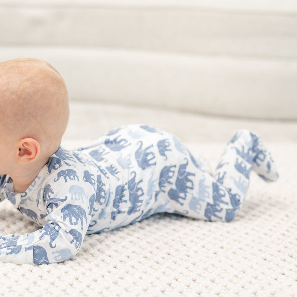 Infant light-blue elephant print zipper footie, side view with footed legs